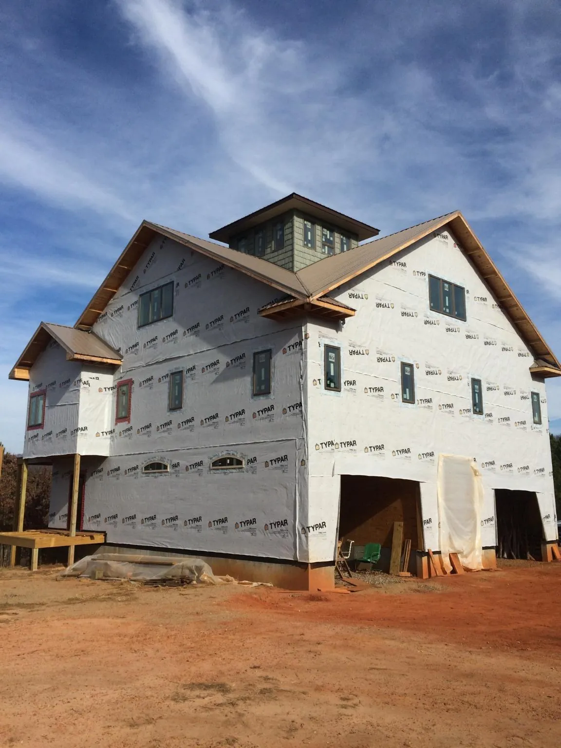 New two story house under construction with a cupola and gabled roofs in Ione